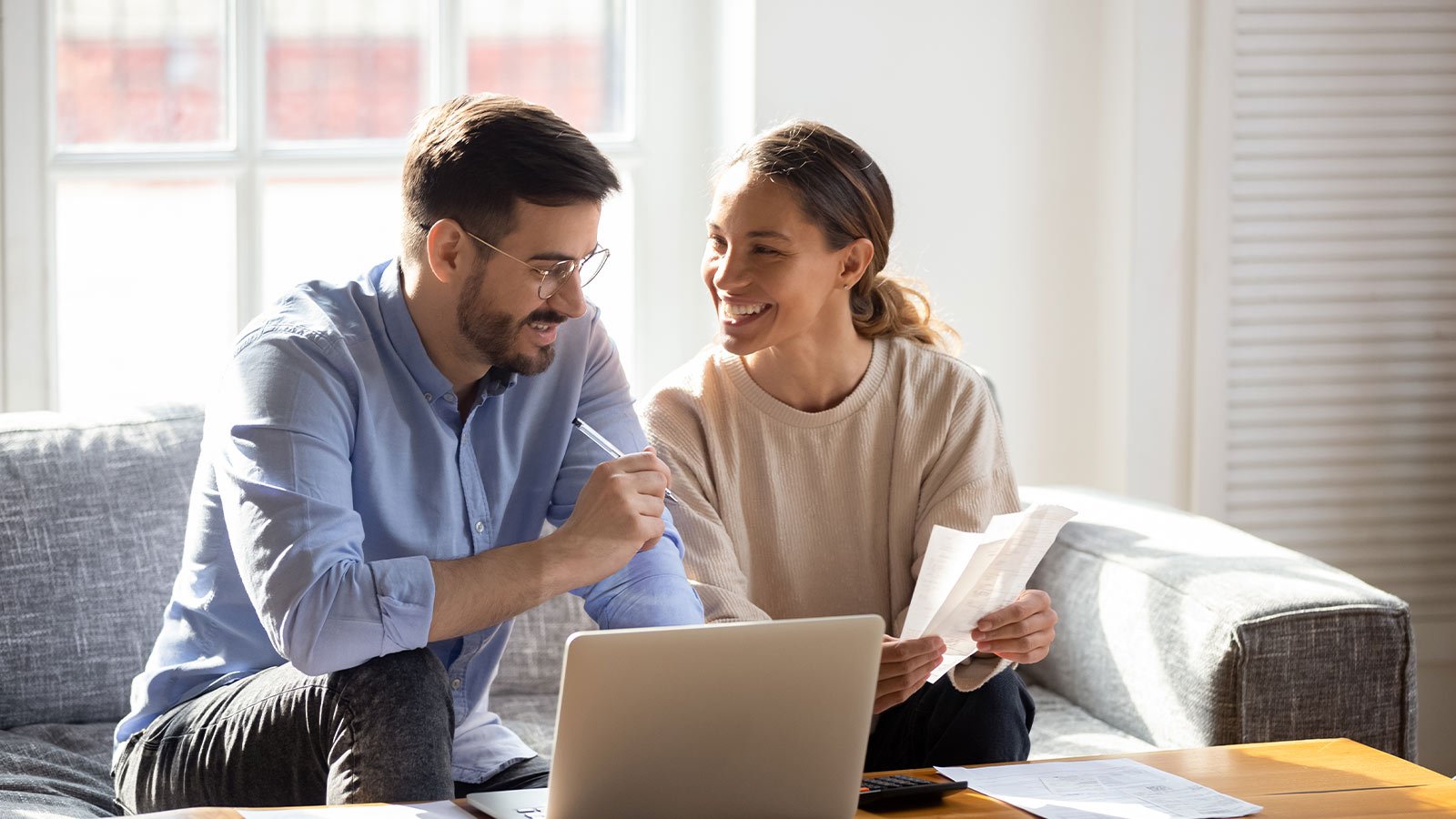 Hombre y mujer sonrientes haciendo un plan de compras